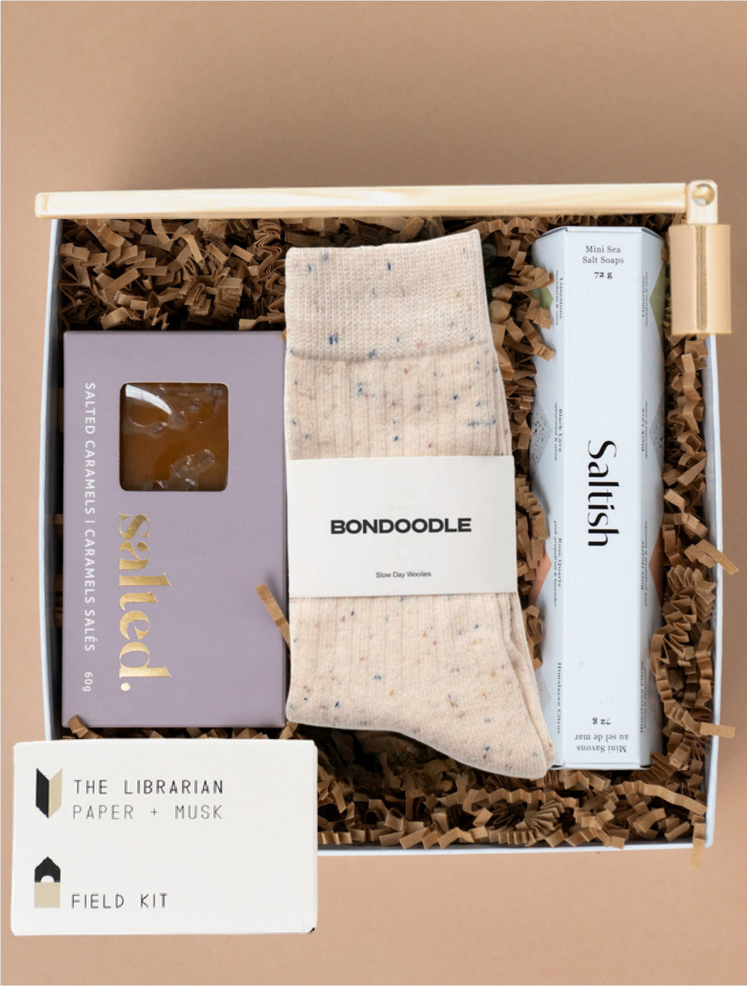 Cozy Retreat gift box with Bondoodle socks, Saltish soaps, Salted caramels, a Field Kit candle and gold snuffer.