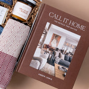 Amber Lewis's Call It Home design book beside a woven Pokoloko towel in a gift box.