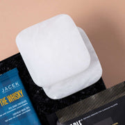Two alabaster coasters beside JACEK Whiskey Chocolate and Eatable popcorn.