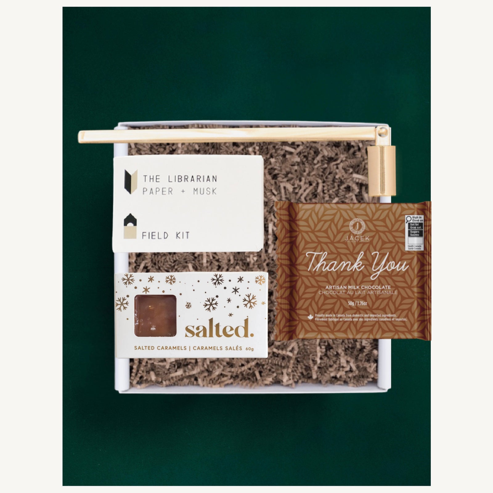 Thank You gift selection with a JACEK Thank You bar, Salted caramels, a Field Kit candle and gold candle snuffer.