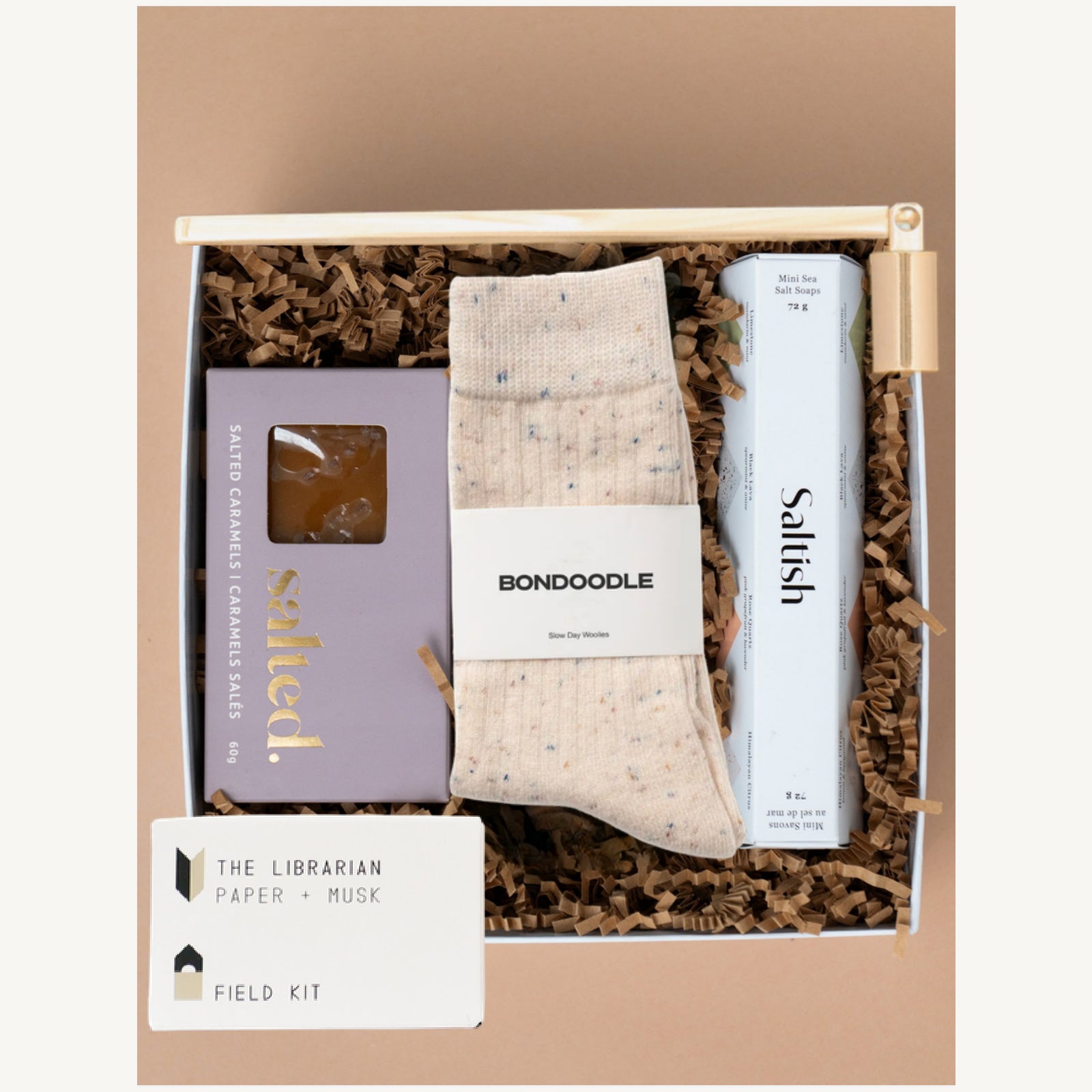 Cozy Retreat gift box with Bondoodle socks, Saltish soaps, Salted caramels, a Field Kit candle and gold snuffer.