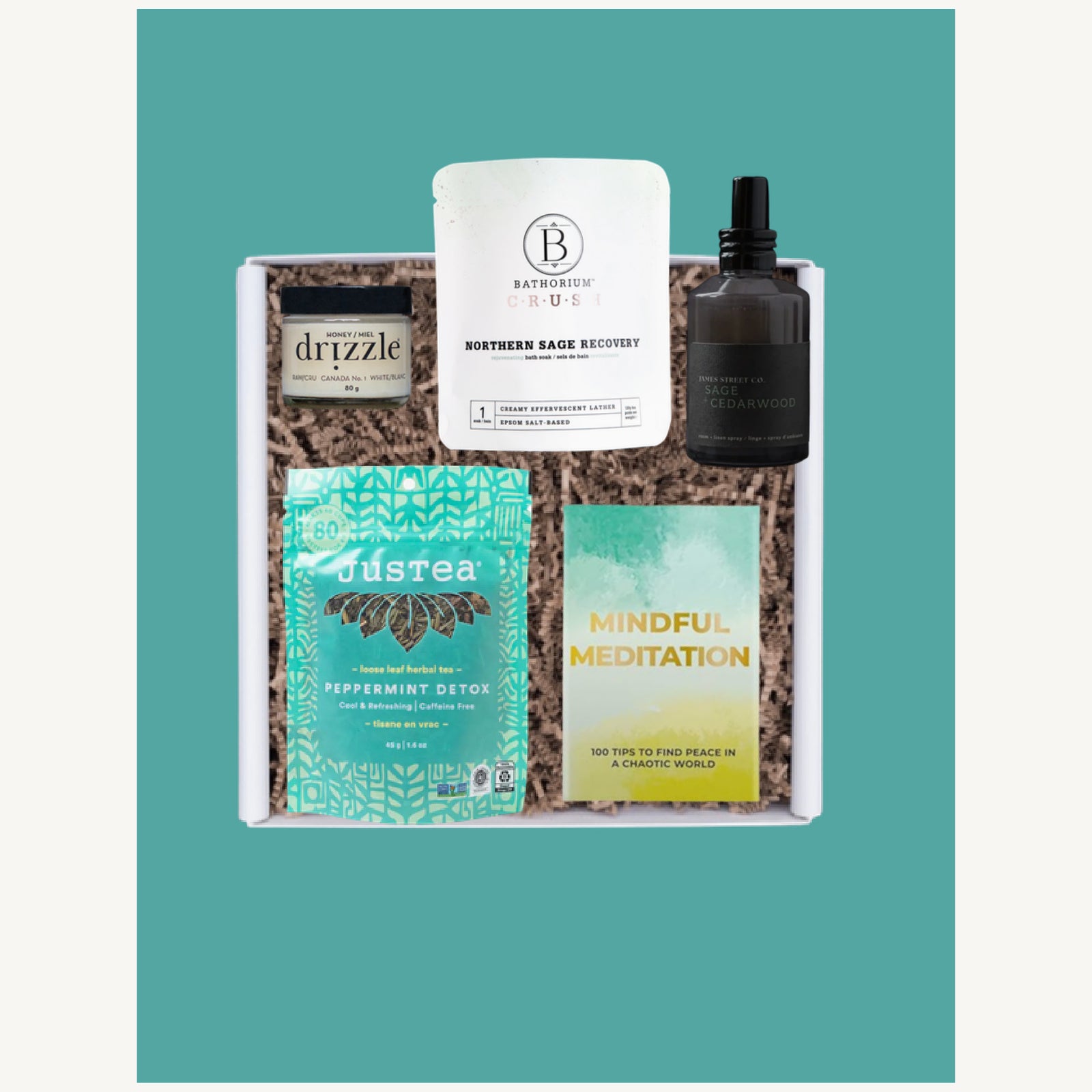 The Deep Rest corporate wellness gift box opened with JusTea herbal tea, Drizzle honey, Bathorium bath soak, linen spray and meditation cards.