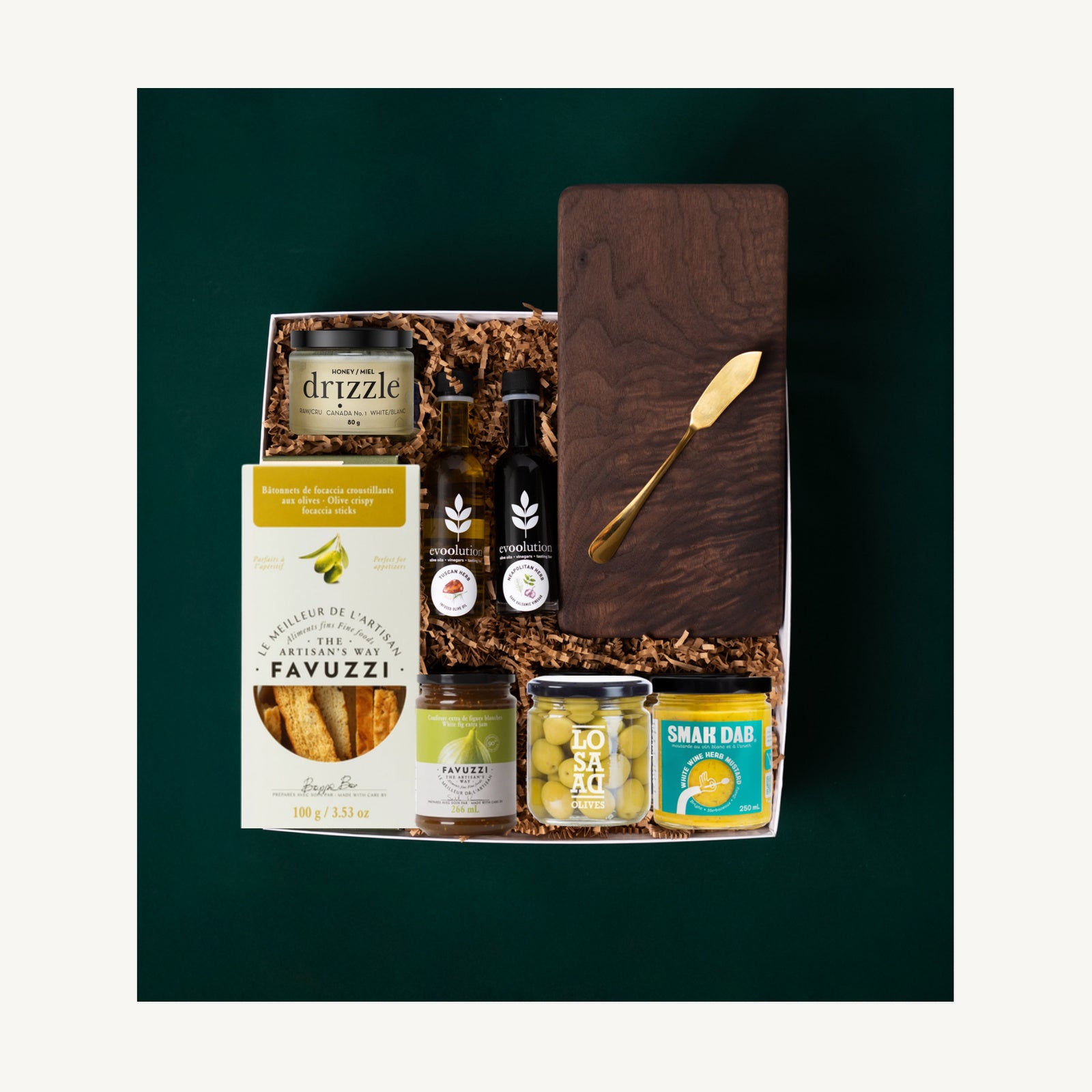 The Charcuterie gift selection with a walnut board, gold butter knife, Drizzle honey, Evoolution oils and gourmet spreads.