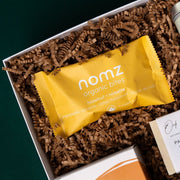 Nomz hazelnut organic date bites in The New Home gift box.