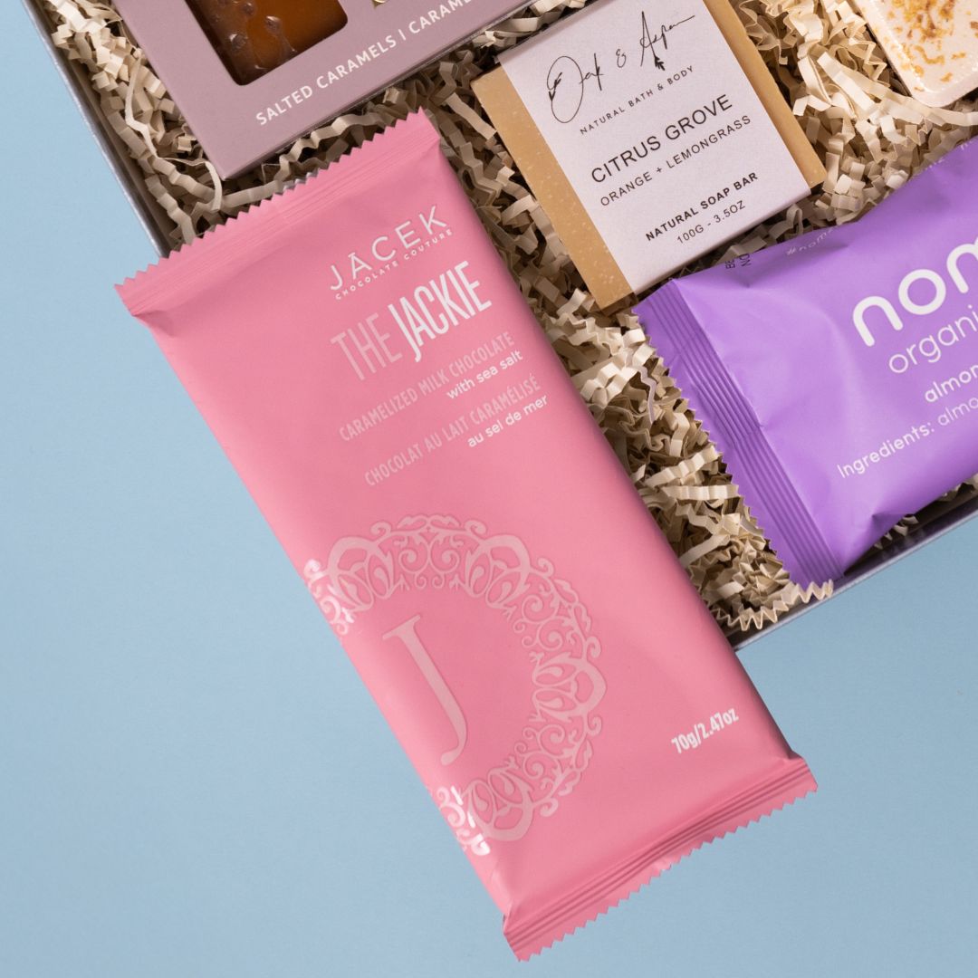 JACEK chocolate bar beside Oak & Aspen soap and Nomz almond date bites.